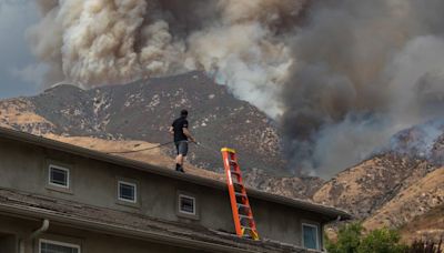 Residents flee as California and Nevada wildfires get dangerously close and forecasters warn of record heat