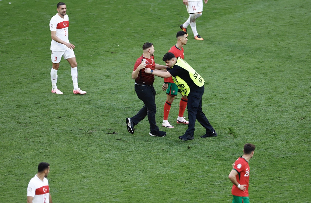 ‘It is a concern, today we were lucky”: Martinez calls for fans to stay in stands as pitch invaders swarm Ronaldo