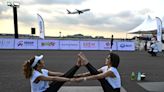 'Feel like a beautiful bird': hundreds do yoga on Thai airport runway