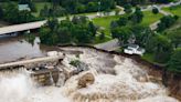 Breached Minnesota dam remains standing amid "historic" flooding