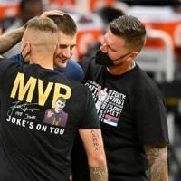 Denver Nuggets star Nikola Jokic, center, is congratulated by his brothers, one of whom is under investigation by the NBA for allegendly punching a fan after a Nuggets victory