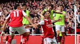 Soccer-Arsenal beat Spurs to stay top, Liverpool held by Brighton