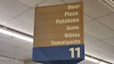 Fact Check: Real Store Sign Listing Beer, Pizza, Guns, and Bibles In One Aisle?