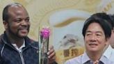 King Mswati III of Eswatini (L) holds his prize next to Taiwan's President-elect Lai Ching-te (R) at the Zhishan Shrimp Fishing Farm