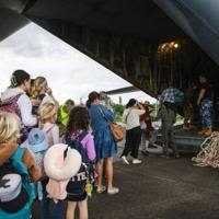 A Royal Australian Air Force C-130 Hercules aircraft evacuating people at Noumea-Magenta Airport in New Caledonia