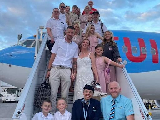 Childhood sweethearts board TUI flight with bridal party in full wedding attire