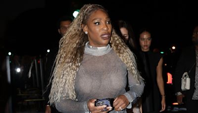 Serena Williams flashes her bra as she gives Edward Enninful a hug