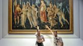 Climate activists in Italy were dragged away by museum staff after they glued their hands to a 540-year-old Botticelli painting, video shows