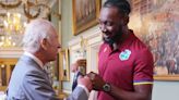 Sweet moment King Charles roars with laughter as he learns how to fist bump