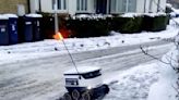 Polite delivery robot thanks couple who free it from icy street