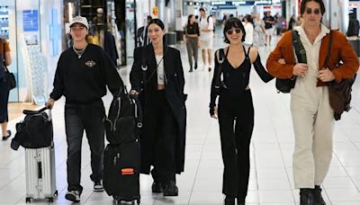 The Veronicas singers Lisa and Jessica Origliasso cuddle up to their partners as they arrive in Sydney for launch of new number one album