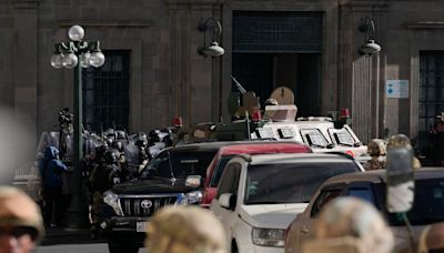 Armoured vehicle breaks through door at Bolivian presidential palace as country faces coup attempt