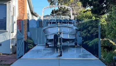 A man ordered to hide his boat painted his new fence with the offending boat. The act of rebellion is changing his city.