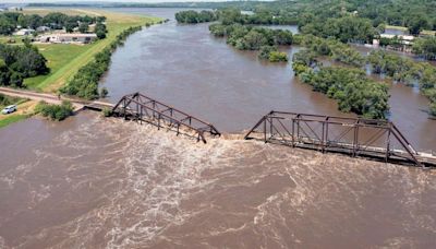 Part of a Minnesota home has plunged into the Blue Earth River as deadly Midwest flooding threatens the nearby Rapidan Dam