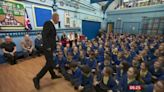 Moment headteacher returns to school months after life was saved by defibrillator he installed