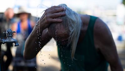 Death Valley sets a new daily record with a searing 128 degrees as West Coast heat wave drags on