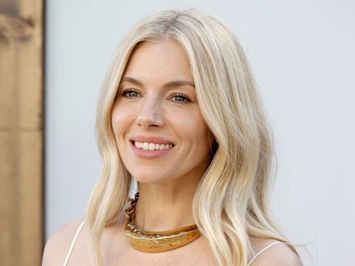 Sienna Miller nails festival fashion in a boho cream maxi dress