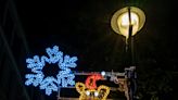 Little helpers from London primary school put up this year's Christmas lights in Soho