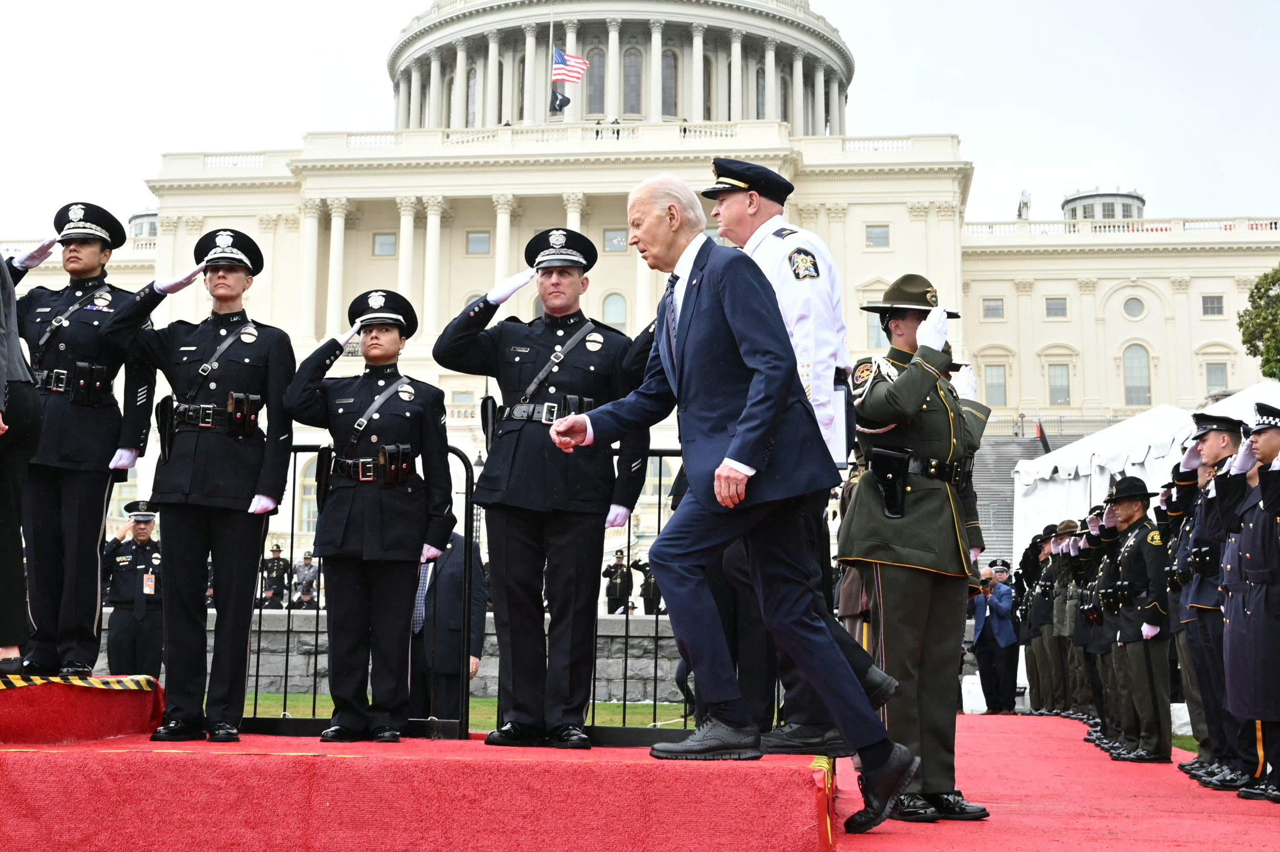 Biden trips on stage at fallen officer's event