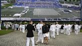 Defense secretary tells US Naval Academy graduates they will lead ‘through tension and uncertainty’