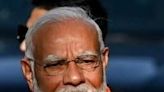 Indian Prime Minister Narendra Modi displays his inked-marked finger after casting his ballot in Ahmedabad on Tuesday