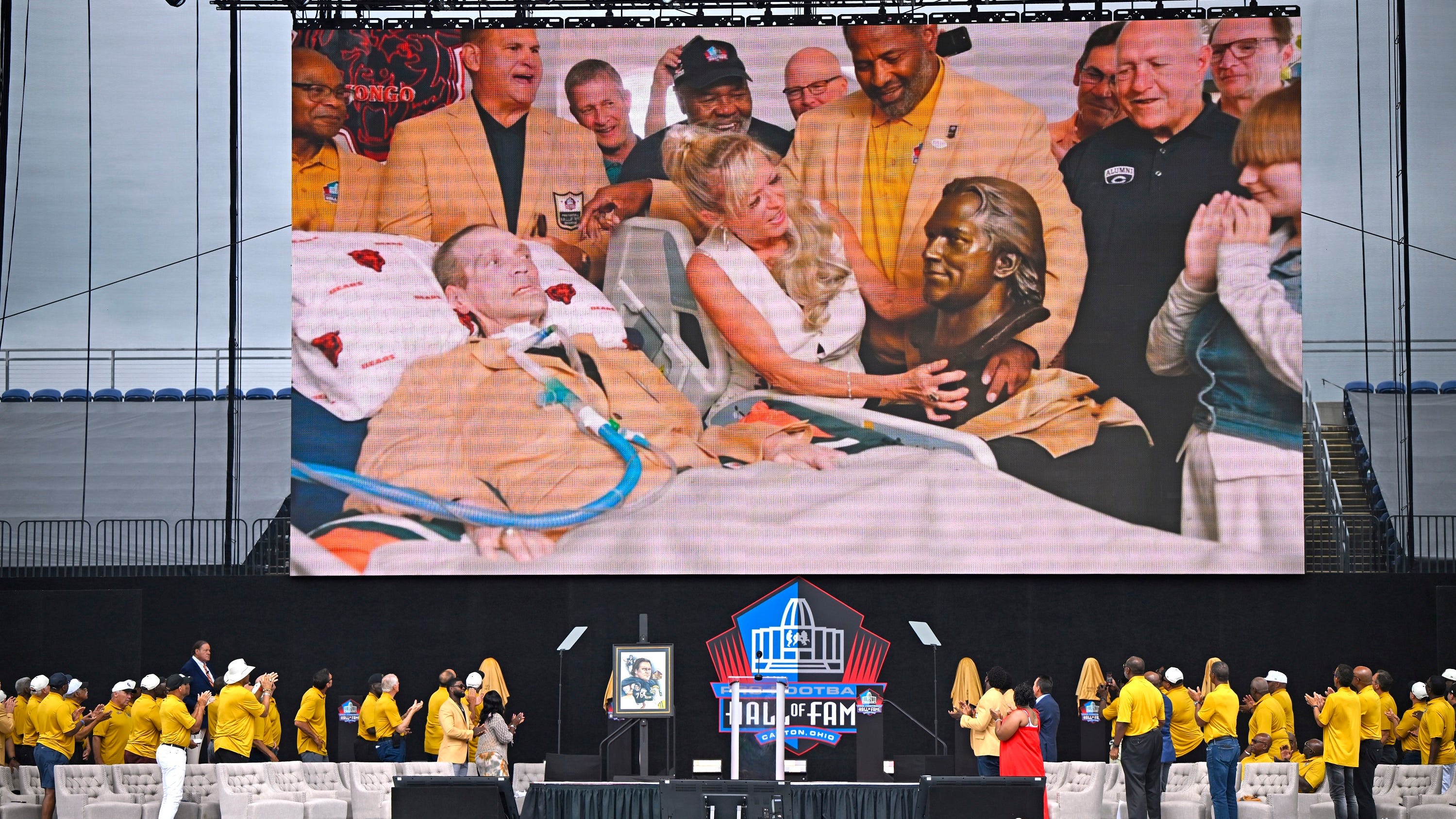 Steve McMichael, who has ALS, enters the Pro Football Hall of Fame in ceremony at home