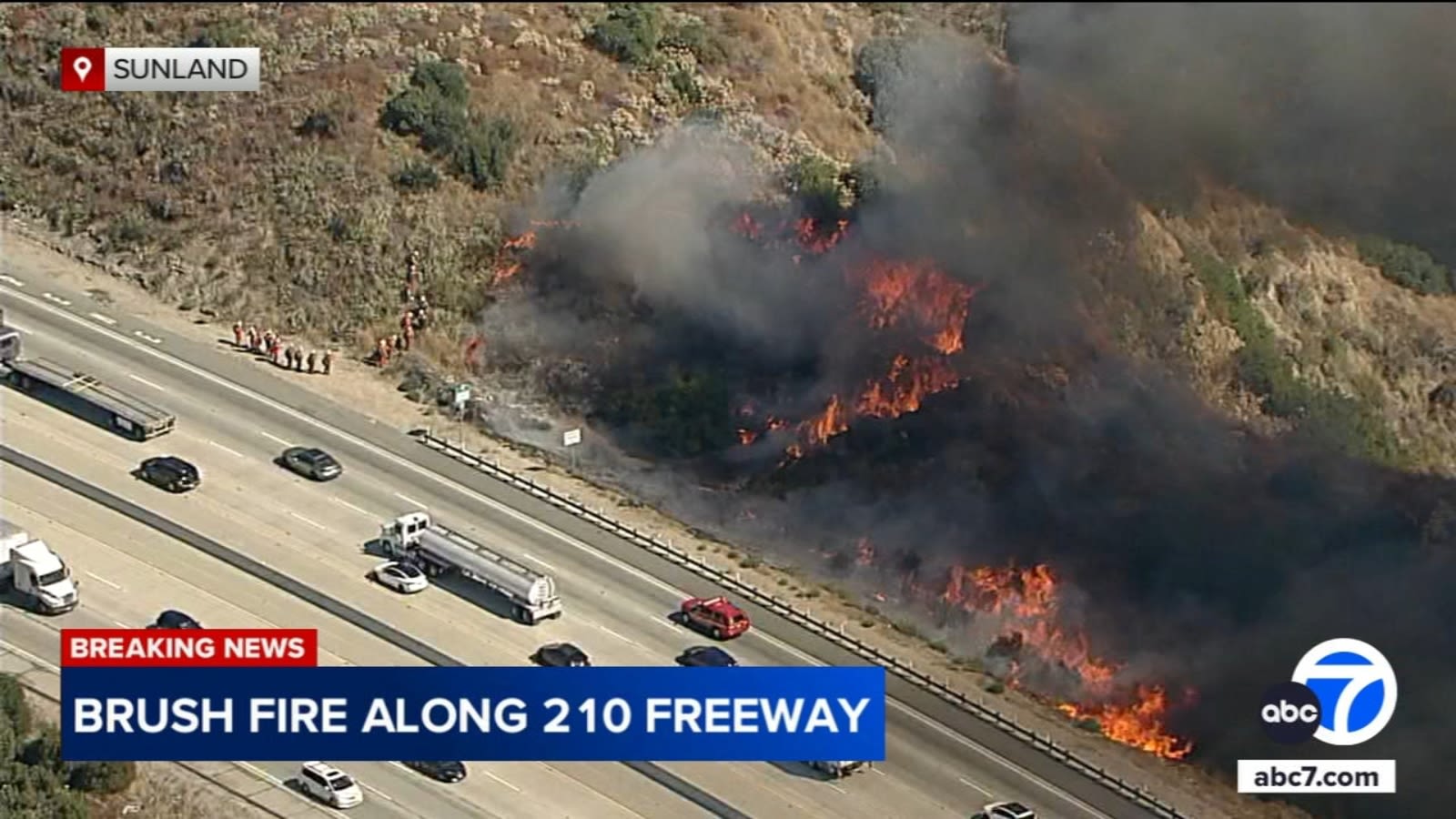 Crews get upper hand on fast-moving brush fire burning along eastbound 210 Freeway in Sunland