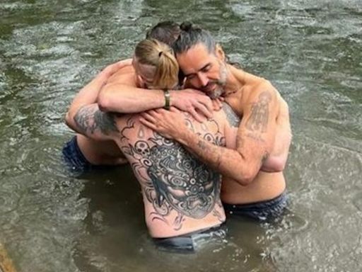 Russell Brand shares new picture embracing Bear Grylls during River Thames baptism