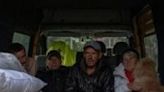 Evacuees from the village of Lyptsi, wait in a minivan at an evacuation point in Kharkiv as Russia presses its offensive