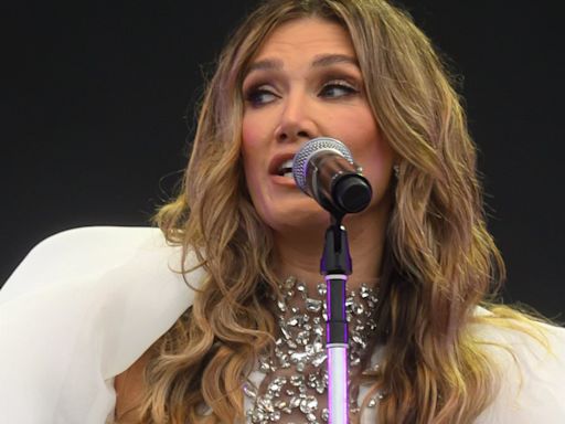 Delta Goodrem's fashion regret sees her carried to stage at festival