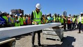 Obama signs steel beam installed on top of presidential center