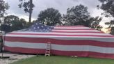 Father and son drape entire house with American flag for July 4th