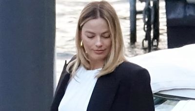 Margot Robbie flashes midriff in cropped white top