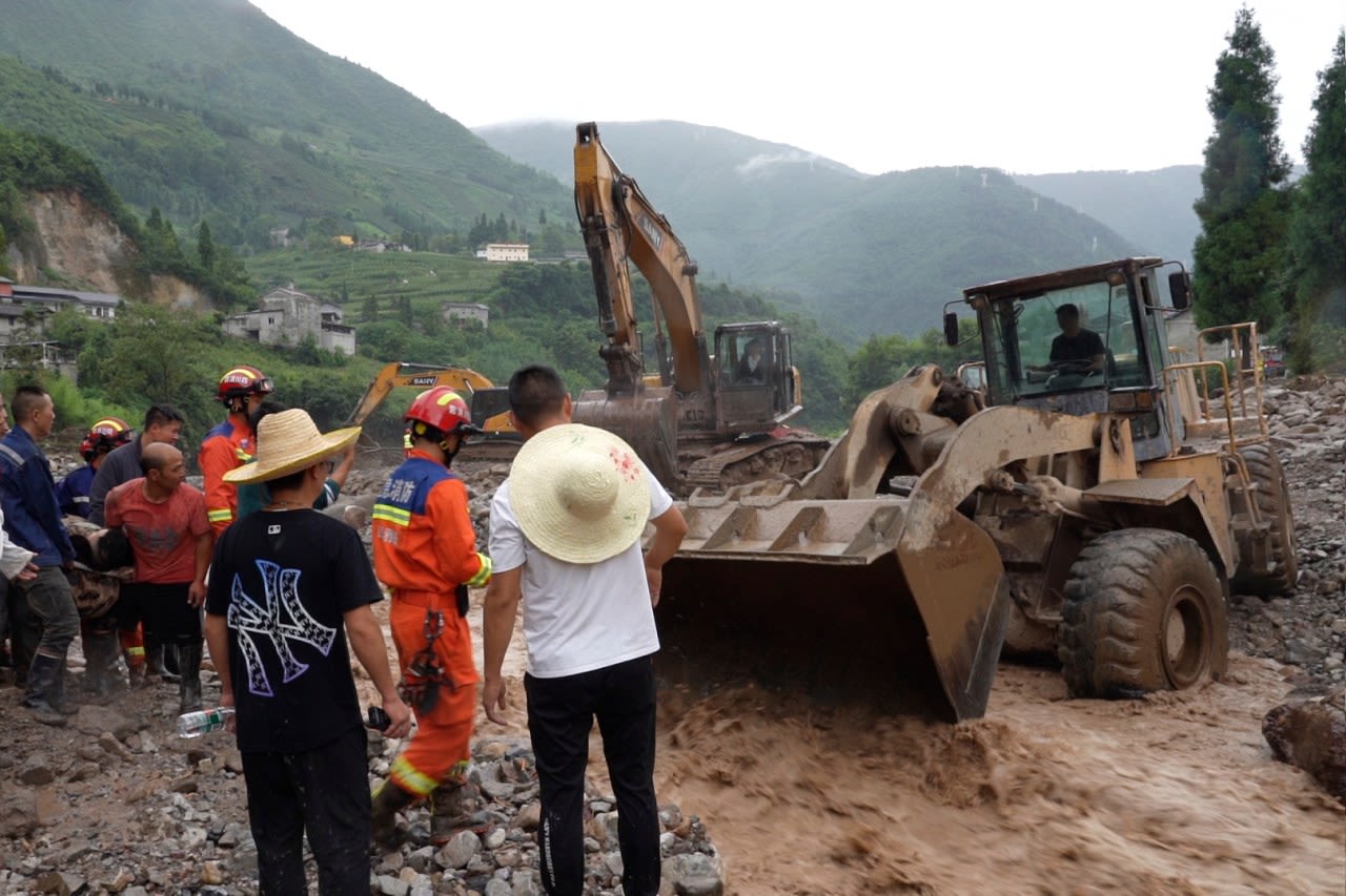 Rescuers search for dozens missing after flooding and a bridge collapse in China kill at least 25