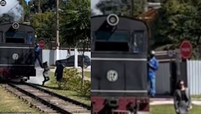 Watch: Driver kicks woman posing for photo near the tracks out of moving train’s way