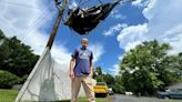 Storm blows trampoline into utility lines, suspending it midair outside home