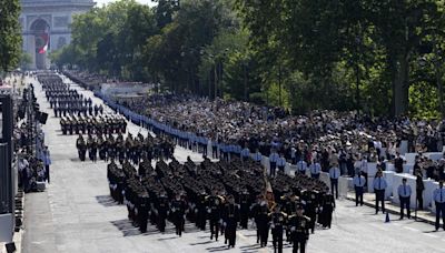 Olympic flame relay merges with France's annual Bastille Day parade