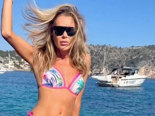 Amanda Holden, 53, branded 'stunning' by fans as she poses on yacht in tiny bikini