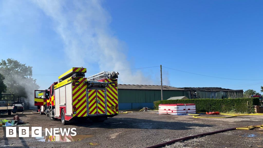 Charlwood: Fire crews work to stop spread of barn fire