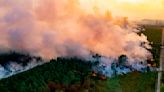 Fires scorch Spain and France, where flames reach the beach