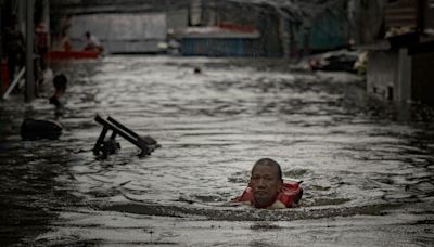 Thousands stranded by floods in Philippine capital as deadly typhoon prompts calls for climate action