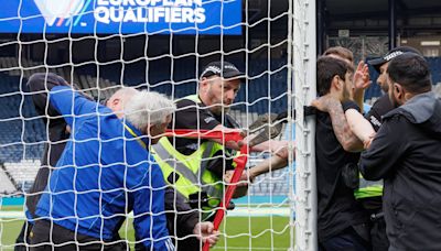 Scotland v Israel Euro qualifier delayed as protester chains himself to goalpost