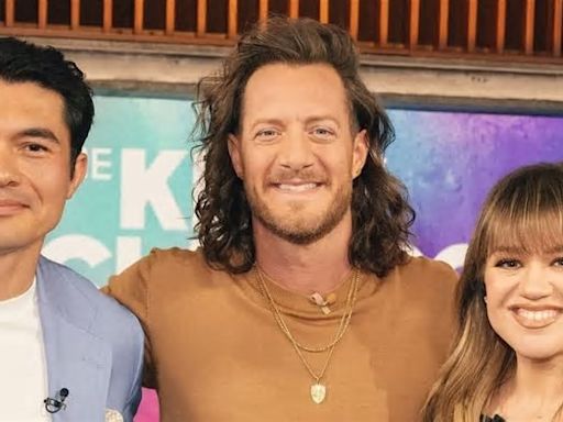 Kelly Clarkson, 41, rocks a little black dress highlighting her 40-pound weight loss for interviews with Henry Golding and Tyler Hubbard