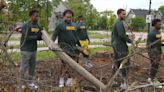 Packers players help clear lot for new Greater Green Bay Habitat for Humanity home build