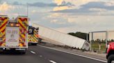 Semi hangs over side of overpass on Polk Parkway