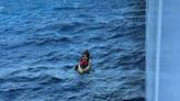 Men stranded at sea after boat sinks are rescued by Carnival cruise ship, photos show