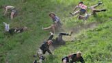 Woman who was knocked unconscious wins England's cheese-rolling race 2023