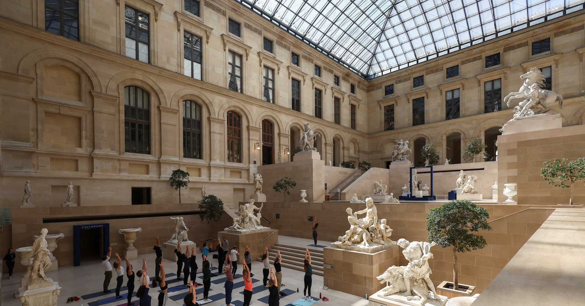 Parisians warm up for Olympics with workouts in Louvre museum