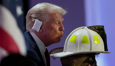 RNC 2024 live: Trump kisses helmet of firefighter killed during rally shooting as he flashes $1m check in speech