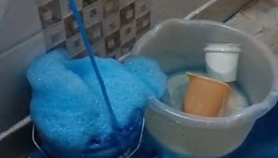 Residents alarmed and mystified as bright blue water flows from taps in homes